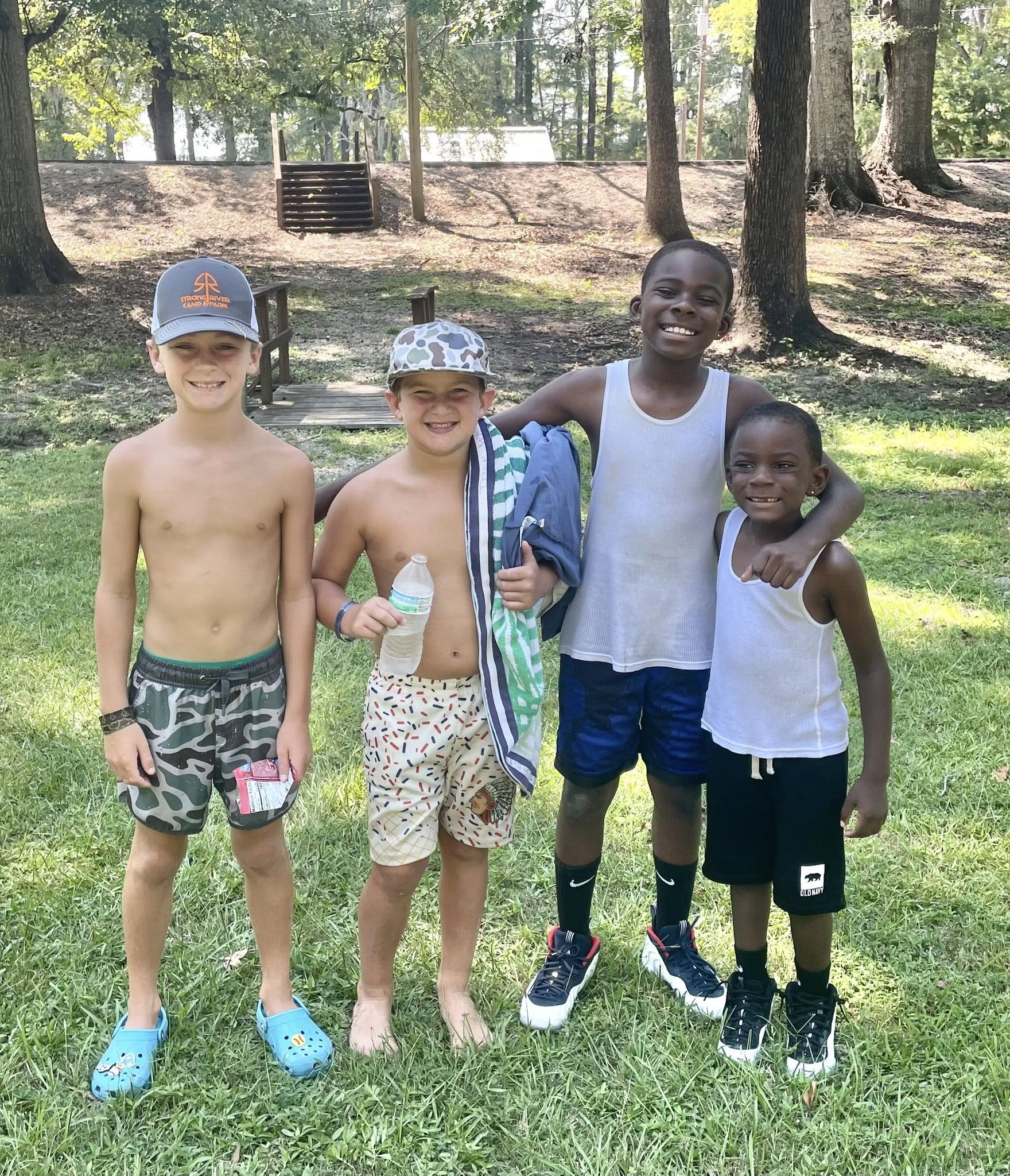 Four young boys posing for a photo.